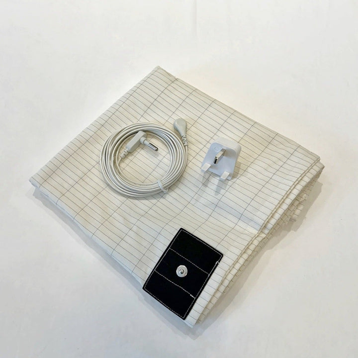 A folded up earthing bedsheet with plug and wire